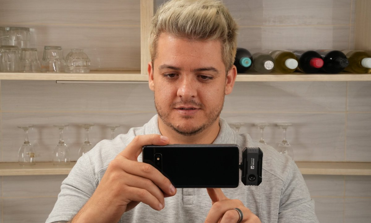 The man was holding a mobile phone thermal imaging camera.