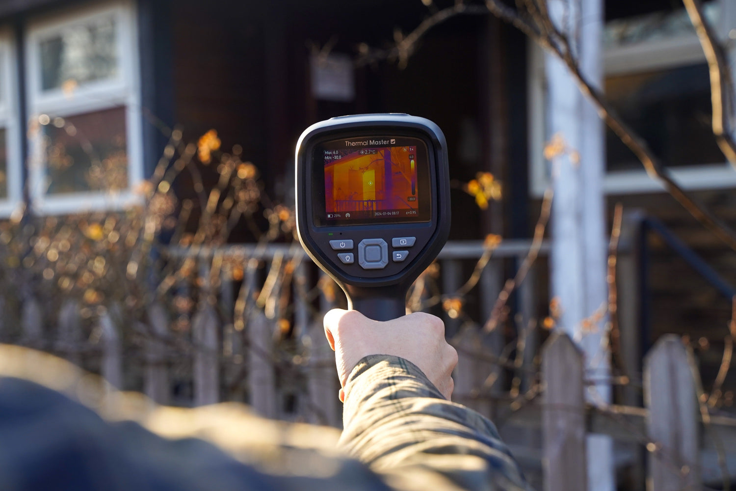 Thermal Master Thor002 handheld thermal camera detecting heat loss during a home inspection.
