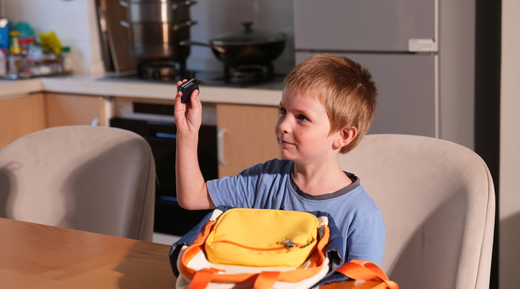 The little boy is holding a small thermal imager