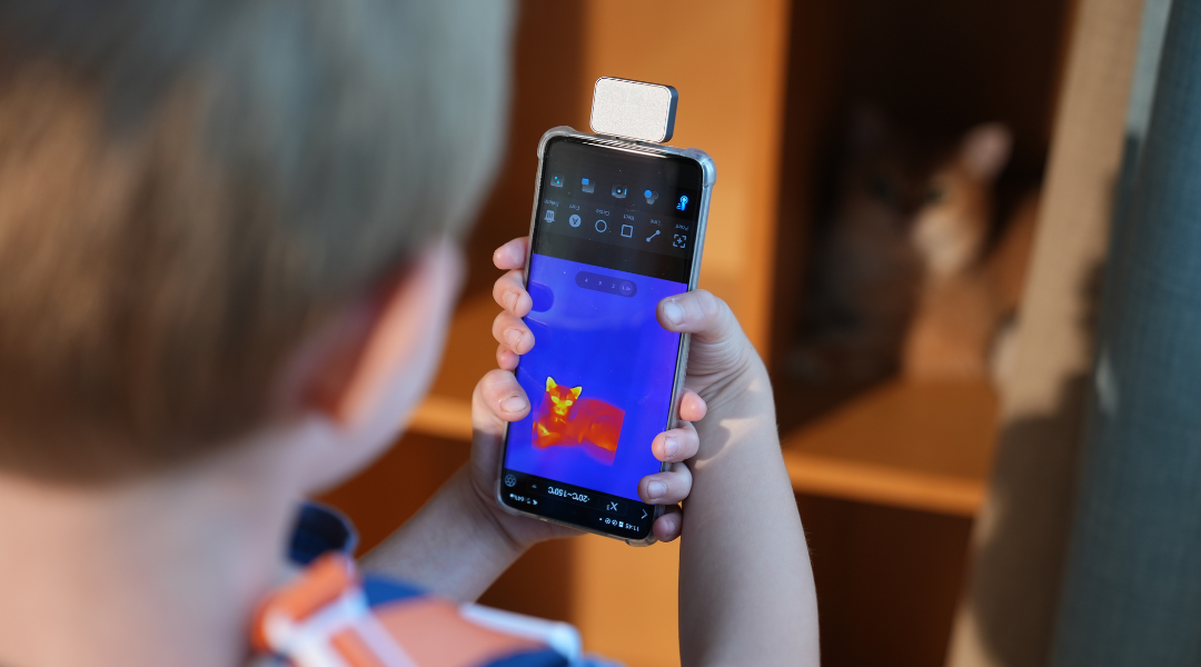 The man was holding a mobile phone thermal imaging camera.