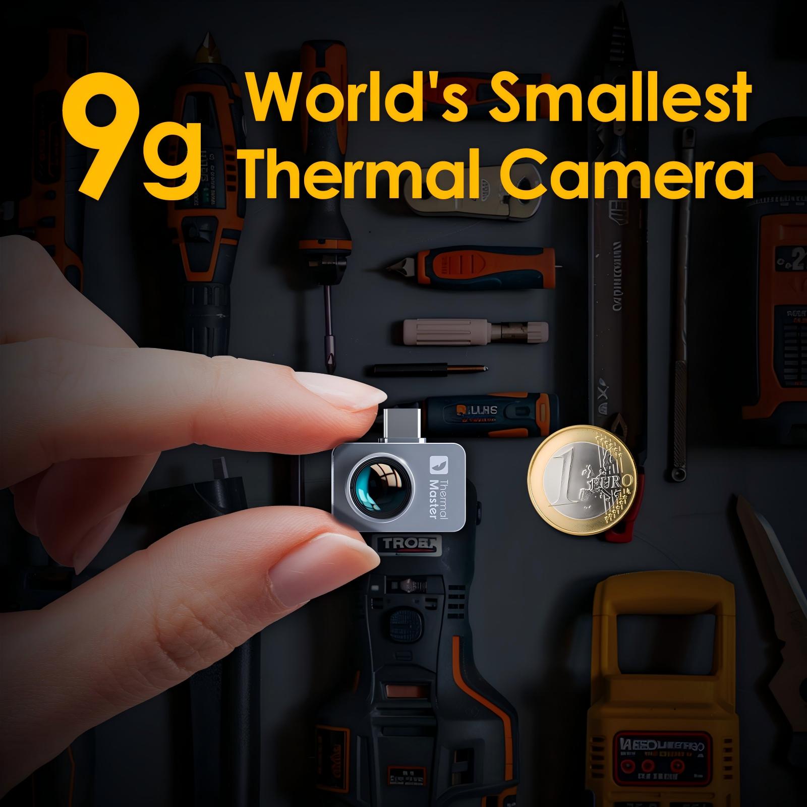 Hand holding Thermal Master 9g world’s smallest smartphone thermal camera beside a 1 Euro coin, with tools in the background.