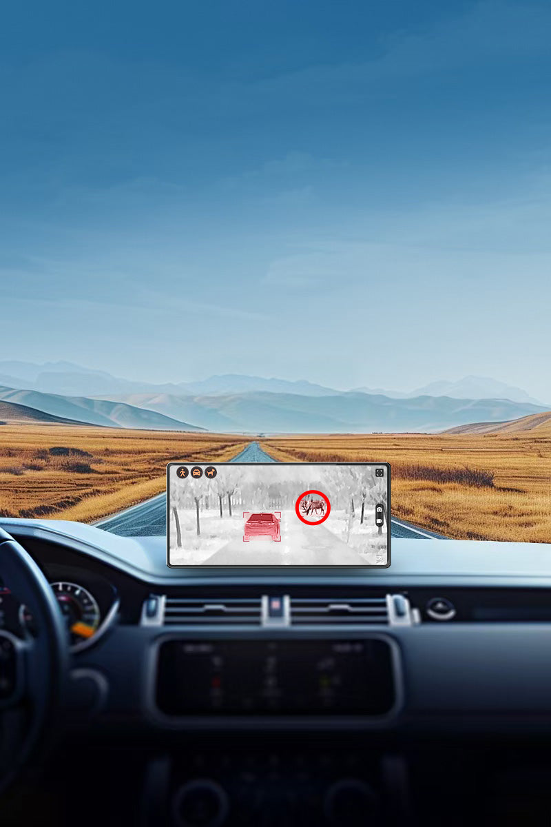 Car dashboard view with Thermal Master car automotive thermal night vision system displaying heat signatures on the road ahead.