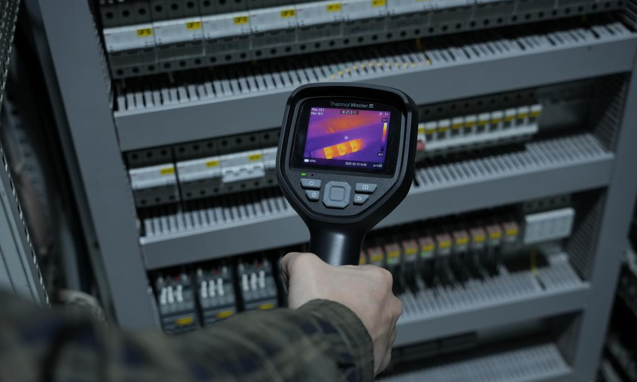 Handheld thermal imager for inspecting electrical boxes.