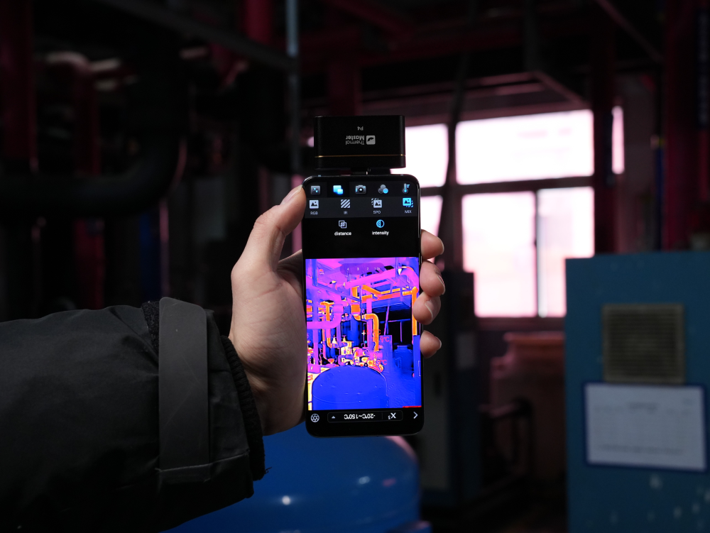 Thermal Master P4 smartphone thermal camera inspecting industrial pipes and equipment with thermal imaging.