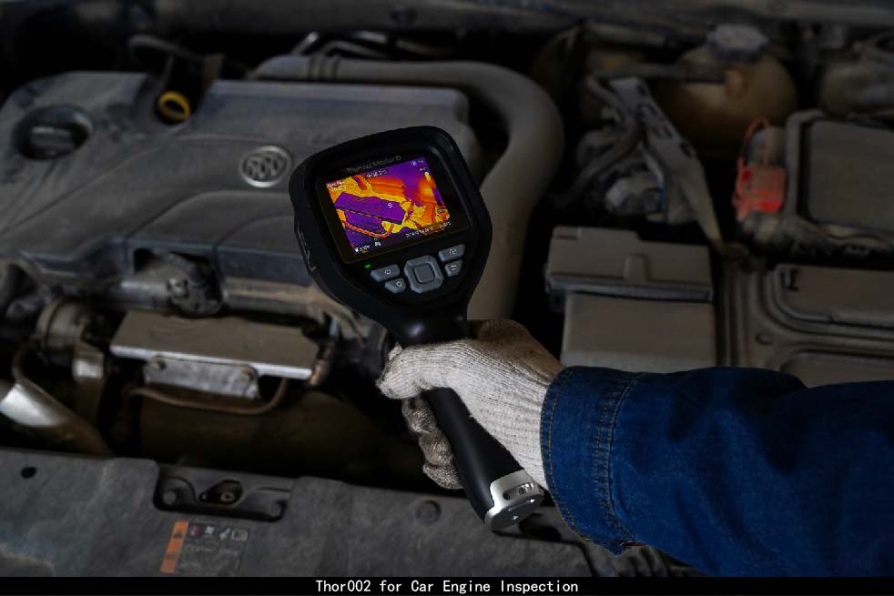 Technician using the Thor002 thermal imaging camera to inspect a car engine for overheating and hidden mechanical issues.