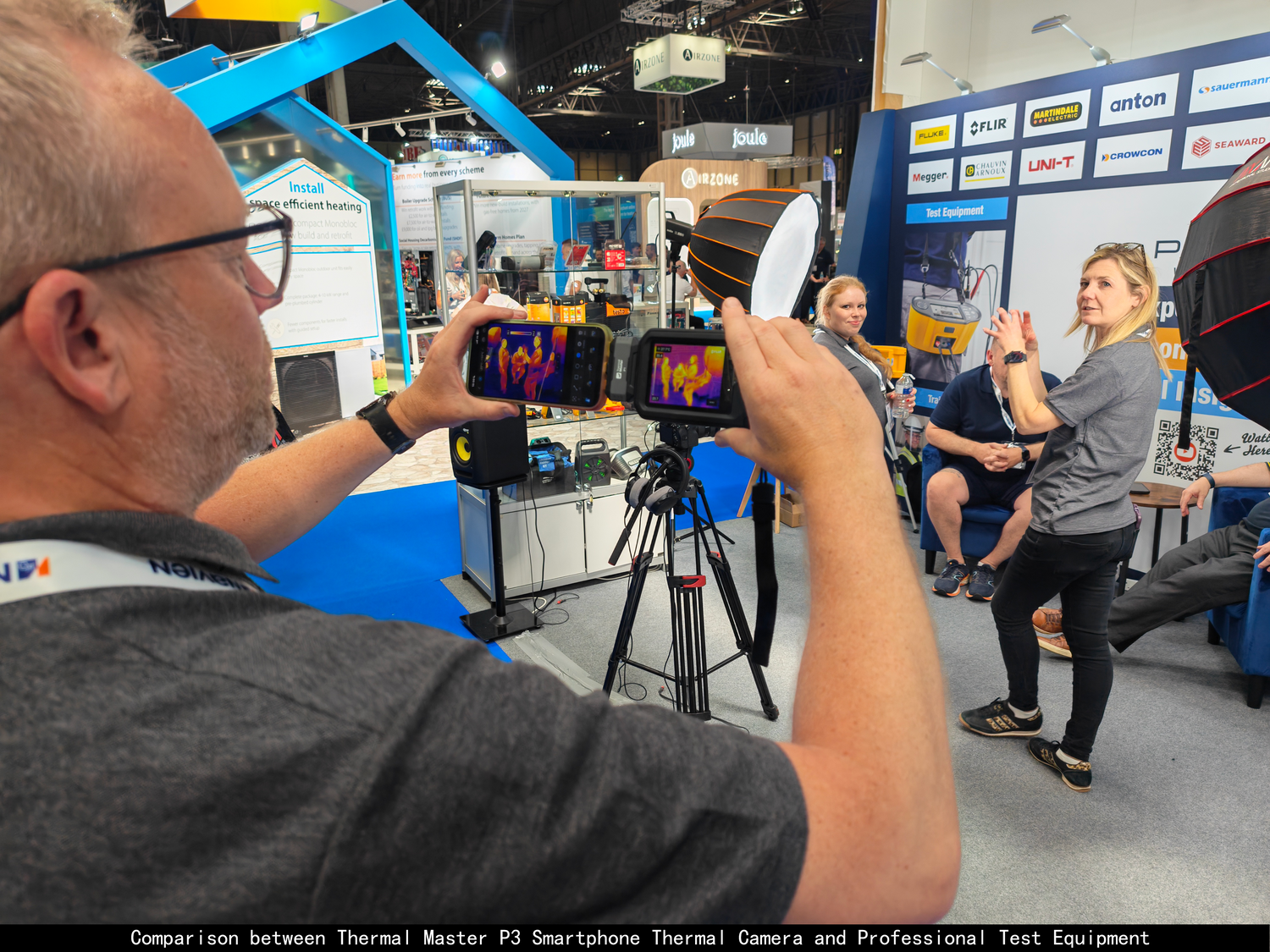 Thermal Master P1 smartphone thermal camera compared with a professional thermal camera at a trade show.