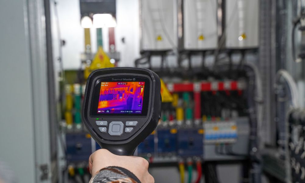 Using a handheld thermal imager to inspect the electrical cabinet